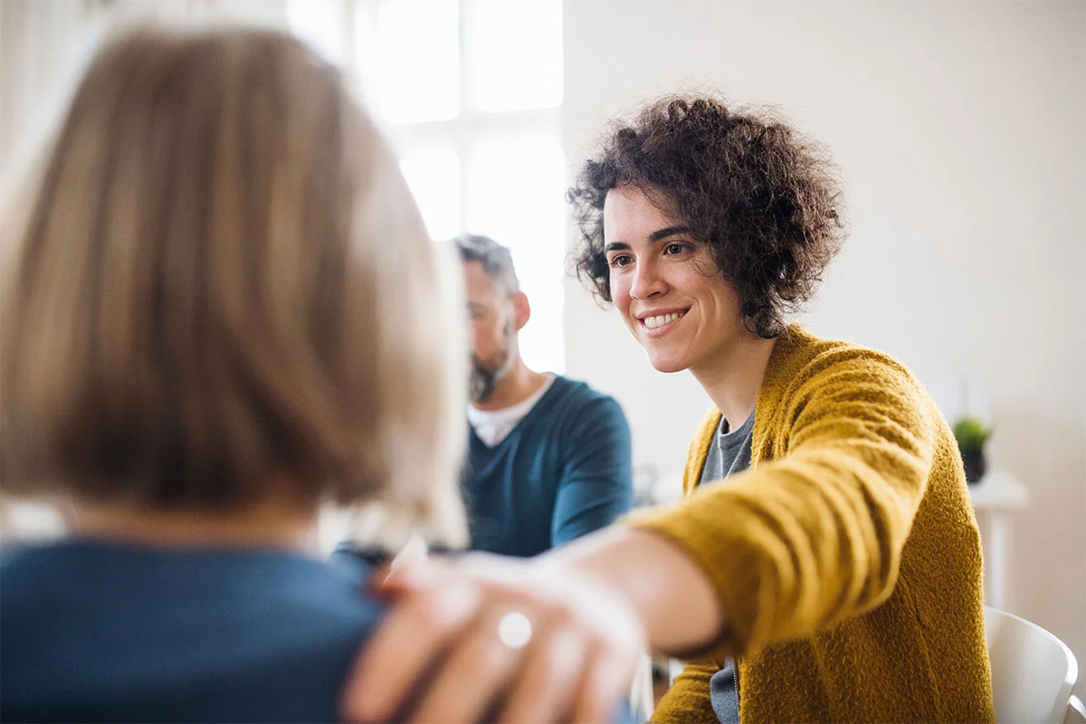 Clients comforting one another during group therapy