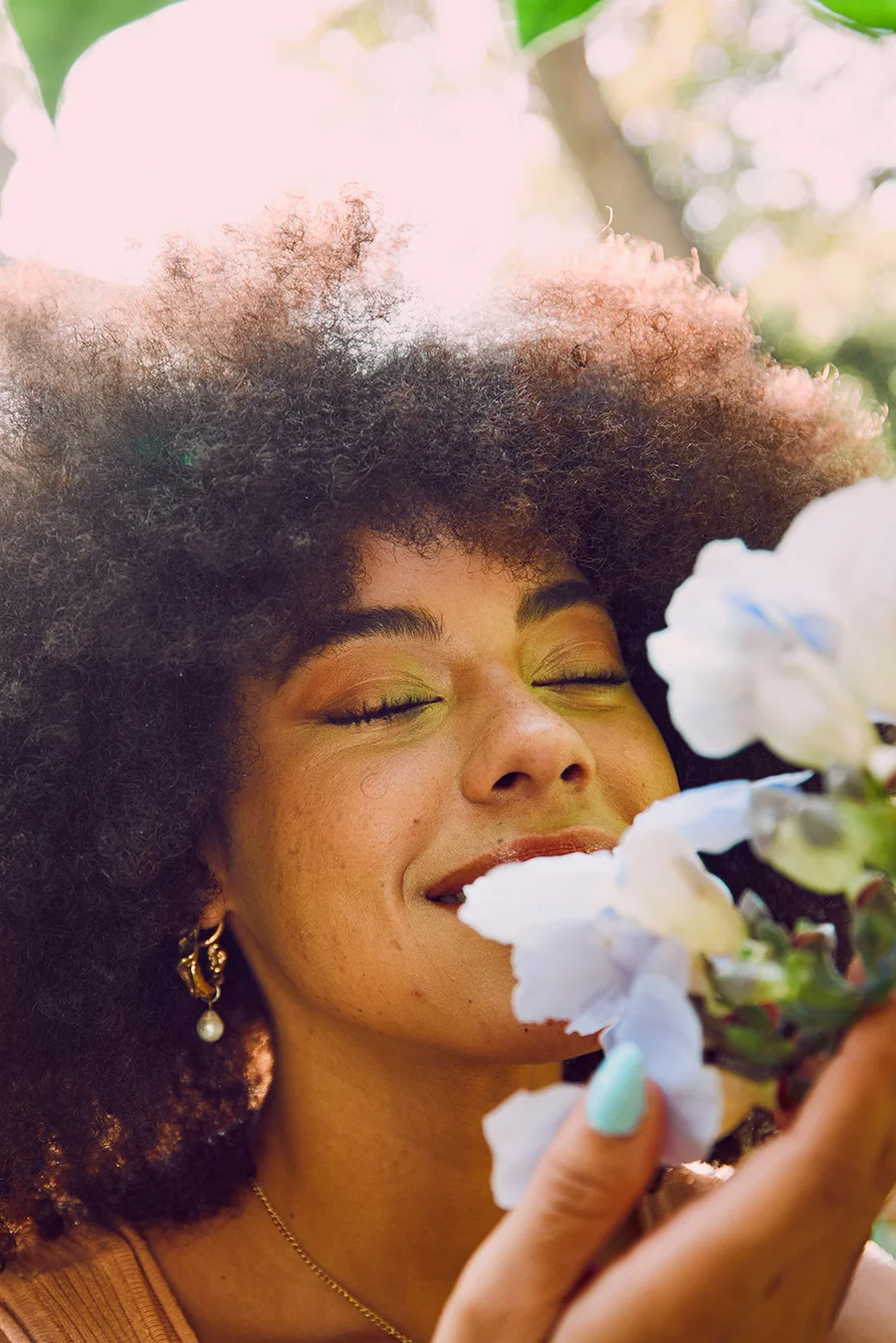 Person smelling flowers and thinking of addiction resources
