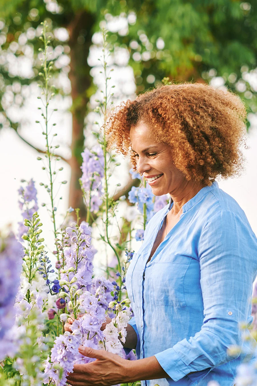 Person appreciating flowers while thinking of medication-assisted treatment