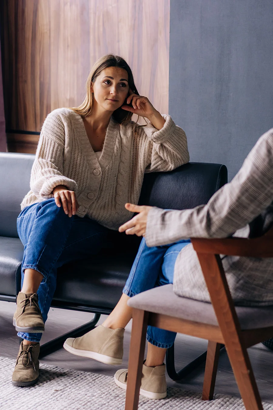 Person sitting and thinking of paying for addiction treatment