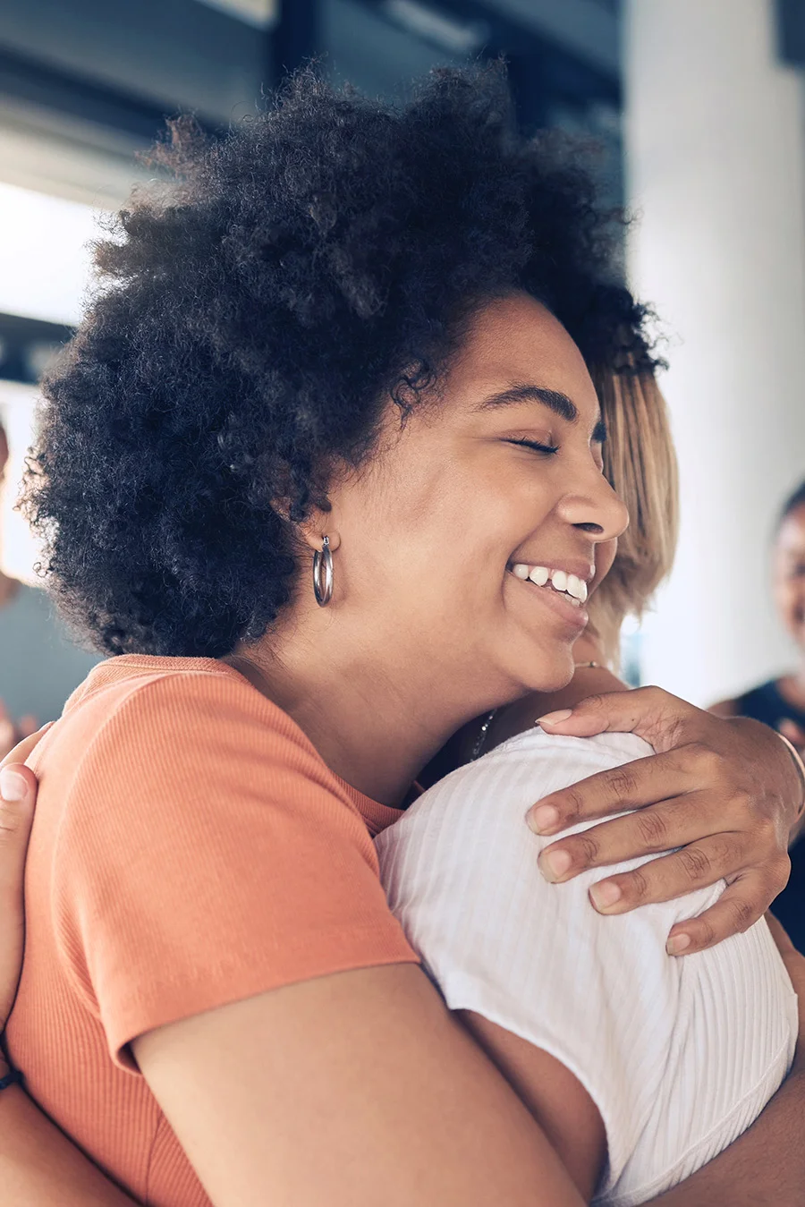 People hugging after paying for addiction treatment