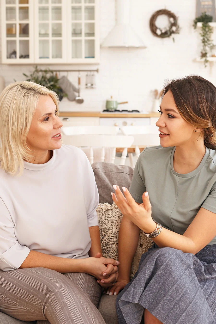 Two people sitting together and talking about addiction treatment programs